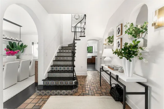 a view of entryway with paintings on the wall