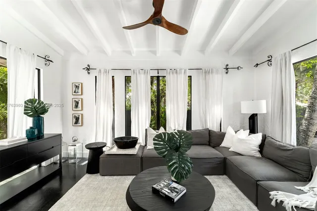 a living room with furniture fireplace and a large window