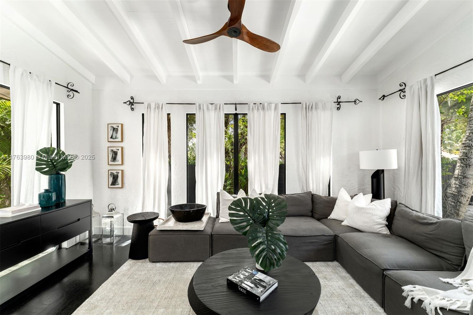 4430 Alton Road Miami Beach, FL 33140 - Photo 6 of 47 a living room with furniture fireplace and a large window