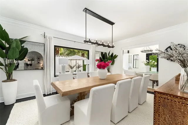 a view of a dining room with furniture and a potted plant