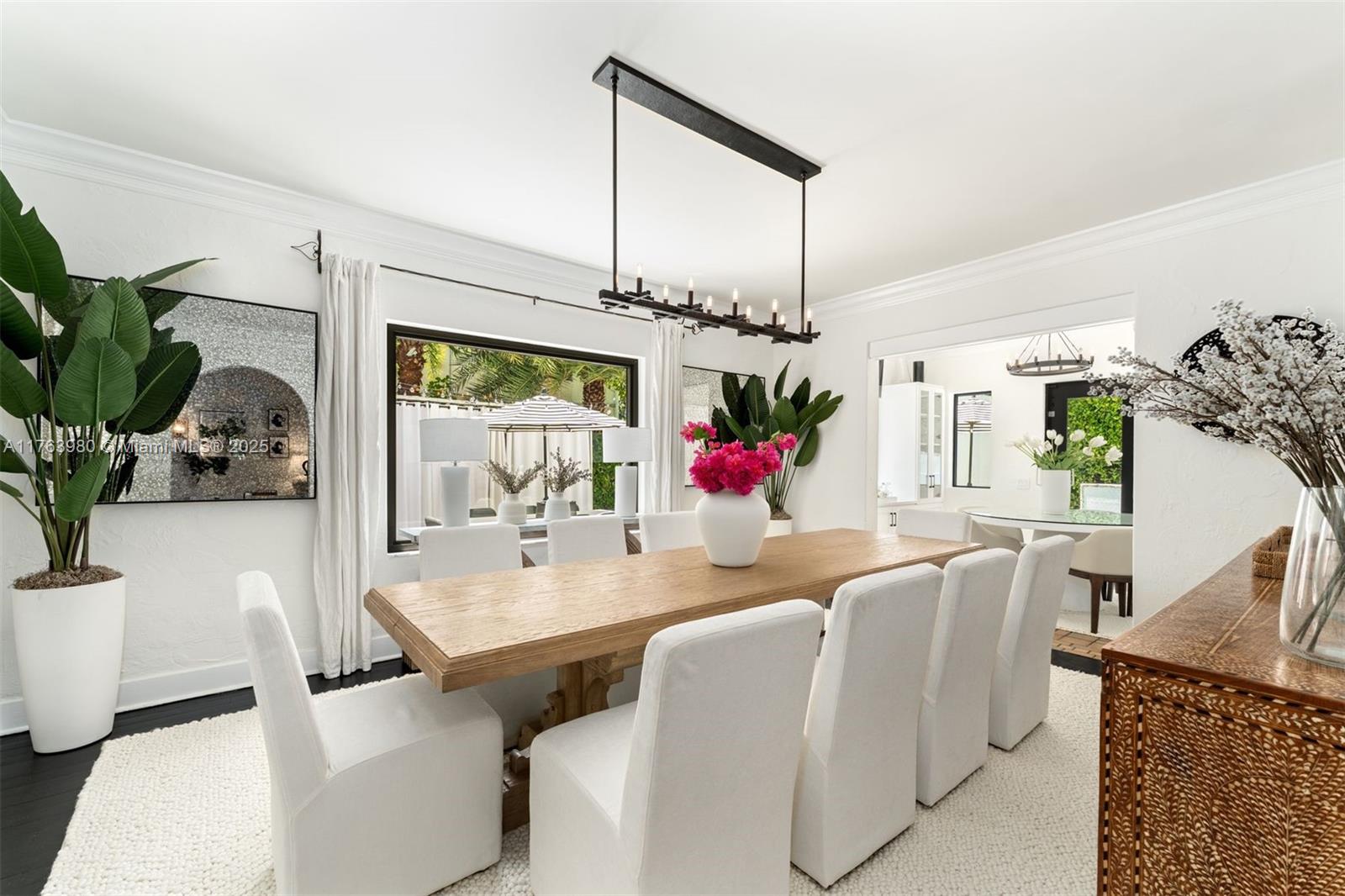 4430 Alton Road Miami Beach, FL 33140 - Photo 10 of 47 a view of a dining room with furniture and a potted plant