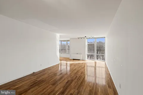 a view of a room with wooden floor