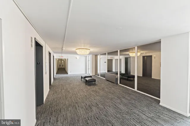a view of hallway with wooden floor