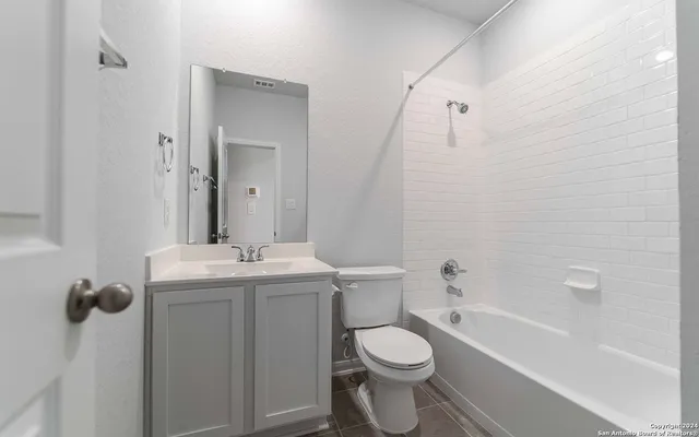 a bathroom with a toilet a sink and bathtub