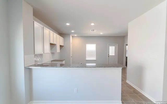 a large bathroom with a sink and a mirror