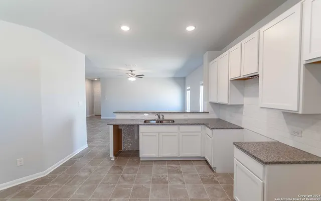 a kitchen with stainless steel appliances granite countertop a sink and a stove