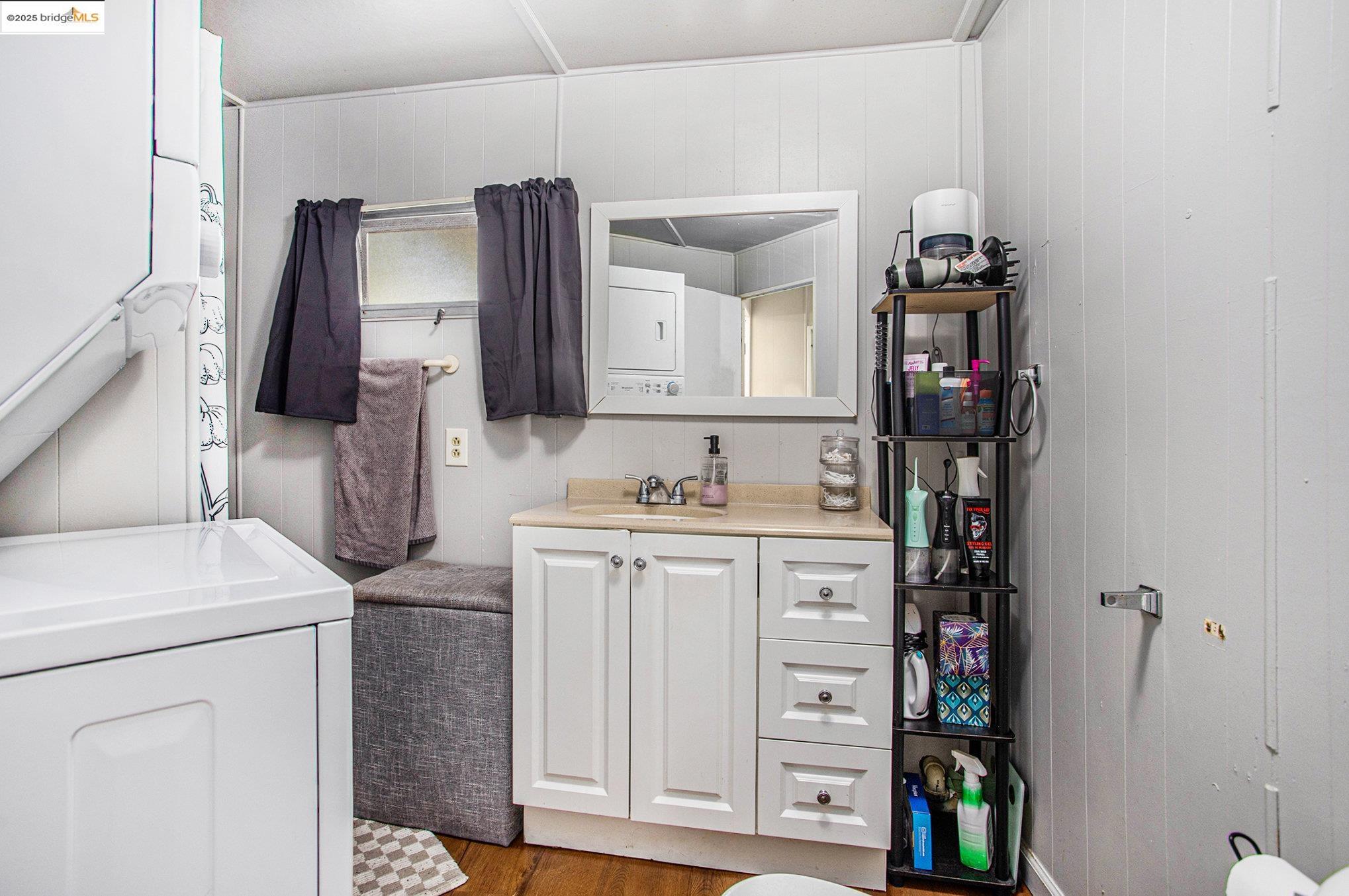 3301 Buchanan Road, Unit 118 Antioch, CA 94509 - Photo 11 of 15 Bathroom featuring washer / dryer, vanity, wood finished floors, and wooden walls