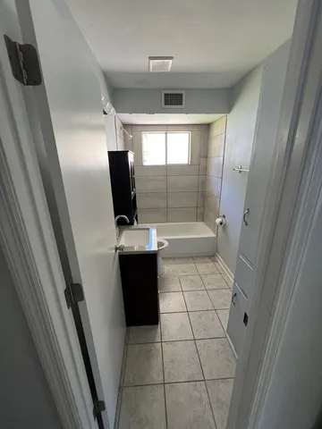 a bathroom with a glass door shower