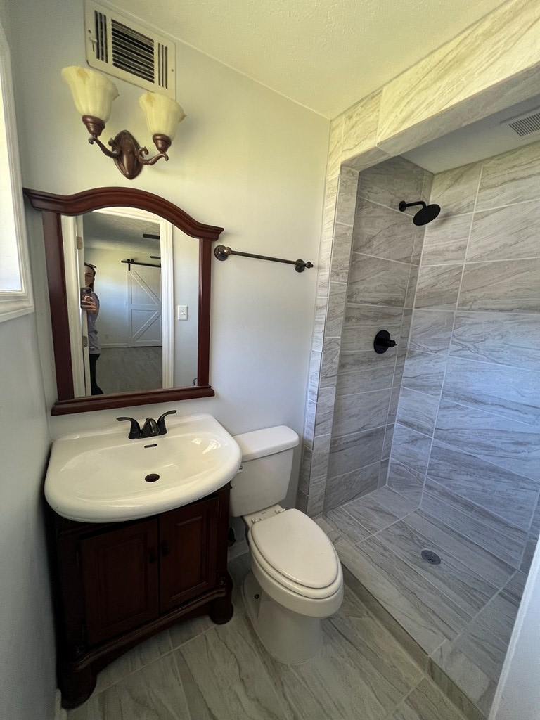 5220 Teresa Street Columbus, GA 31907 - Photo 16 of 21 a bathroom with a toilet a sink and mirror