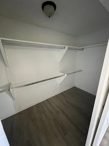 a view of a room with wooden floor