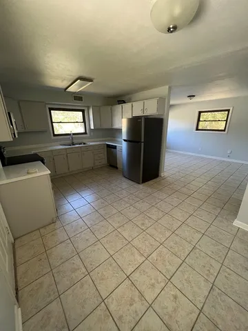 a kitchen with stainless steel appliances a sink and a cabinets
