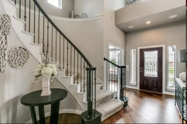 a living room with fireplace furniture and a rug