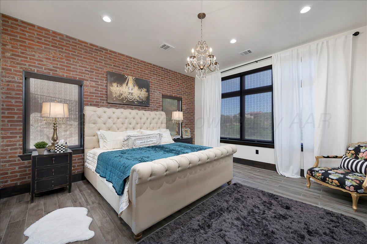 8 Cypress Point Amarillo, TX 79124 - Photo 18 of 43 a spacious bedroom with a bed and a couch