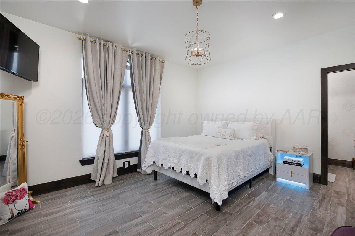 8 Cypress Point Amarillo, TX 79124 - Photo 25 of 43 a bedroom with a bed and a flat screen tv
