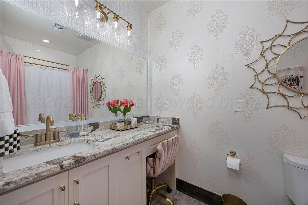 8 Cypress Point Amarillo, TX 79124 - Photo 26 of 43 a bathroom with a granite countertop sink a toilet and a mirror