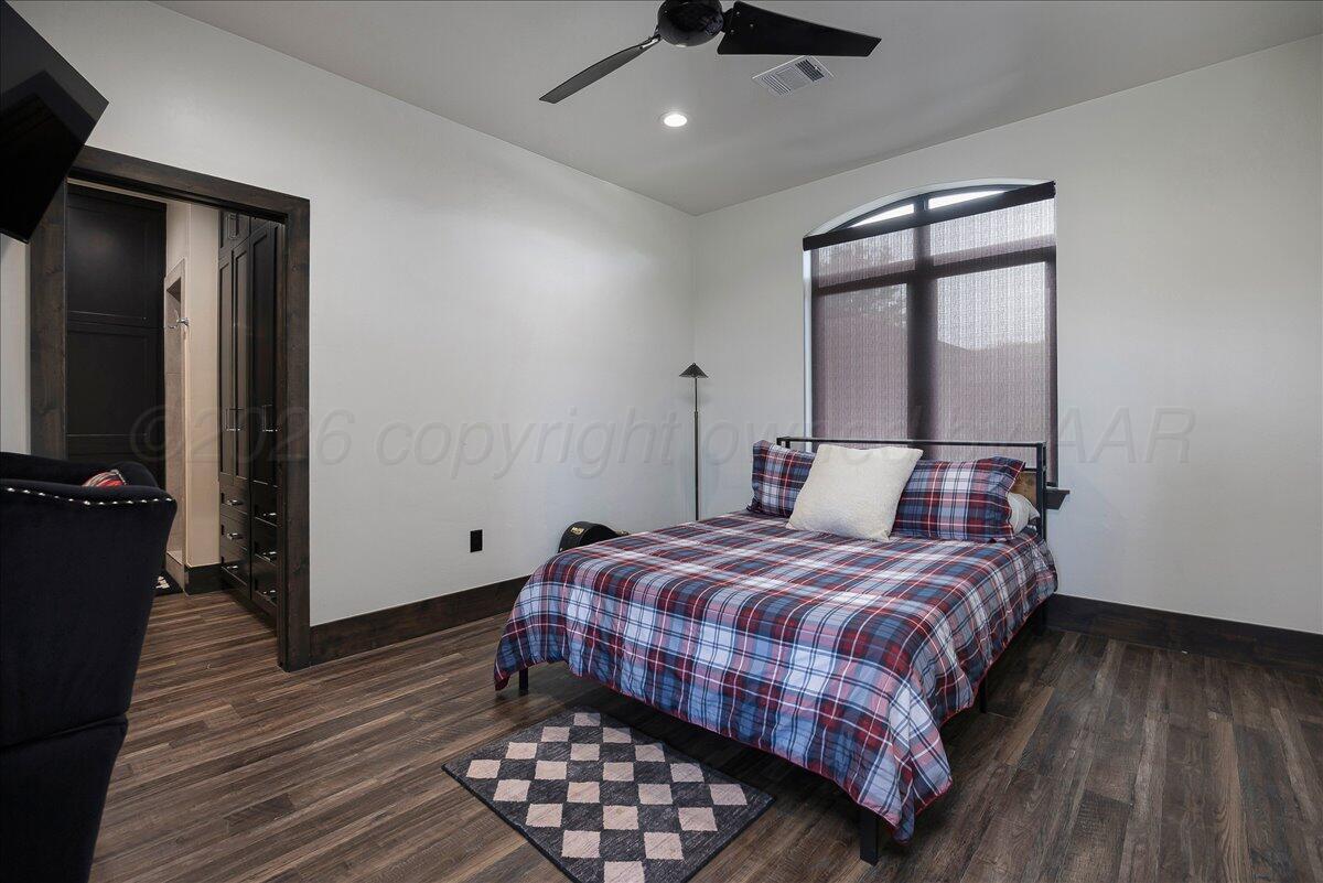 8 Cypress Point Amarillo, TX 79124 - Photo 29 of 43 a bedroom with a bed and wooden floor