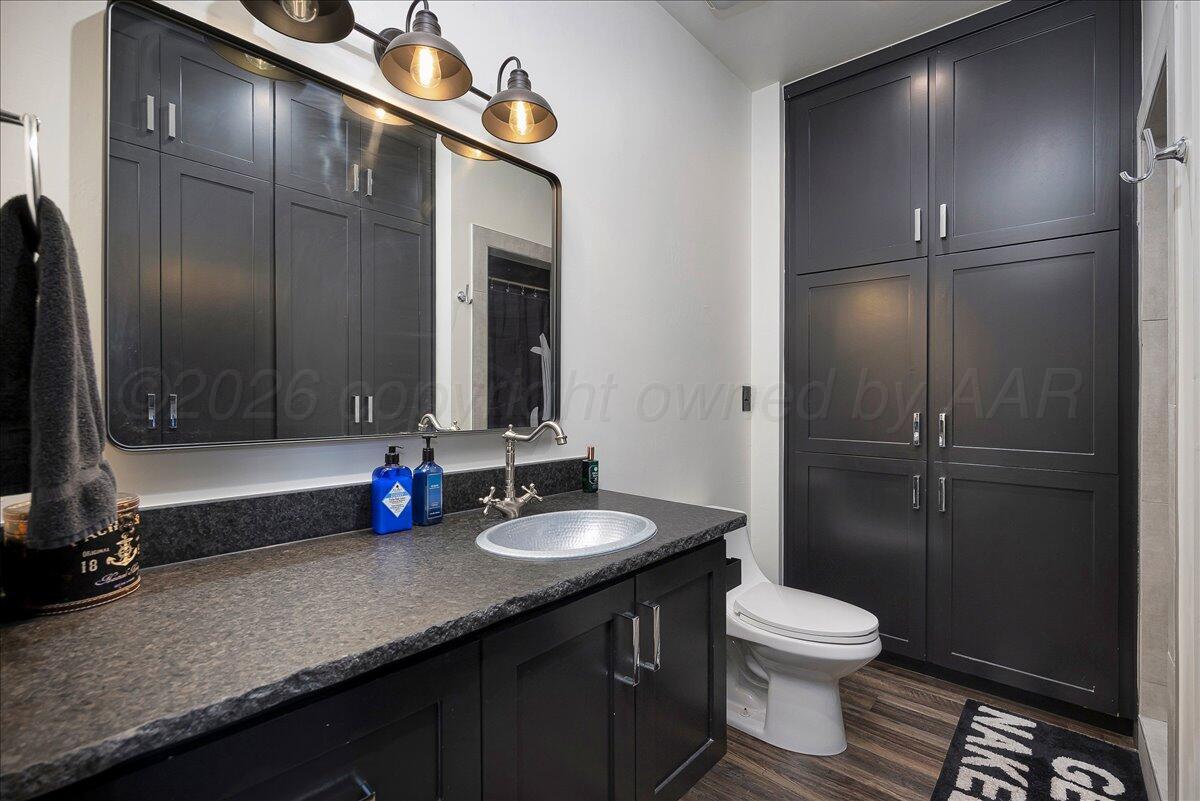 8 Cypress Point Amarillo, TX 79124 - Photo 30 of 43 a bathroom with a double vanity sink toilet and a mirror