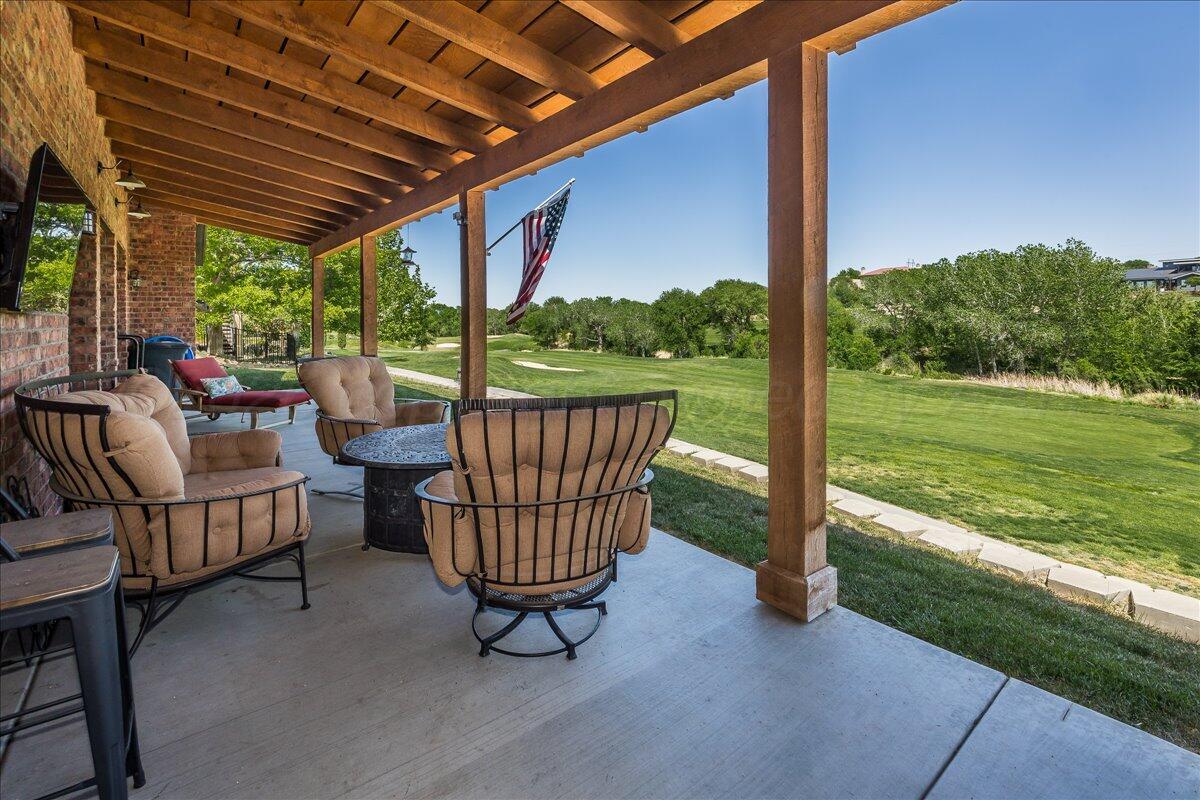 8 Cypress Point Amarillo, TX 79124 - Photo 40 of 43 a view of a chair and tables in the patio next to a yard