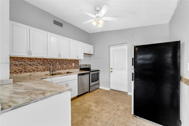 a kitchen with a refrigerator stove and a sink