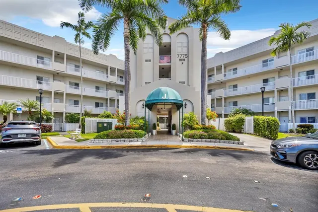 a view of front a building with cars parked