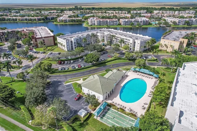 a view of a swimming pool with a garden and trees