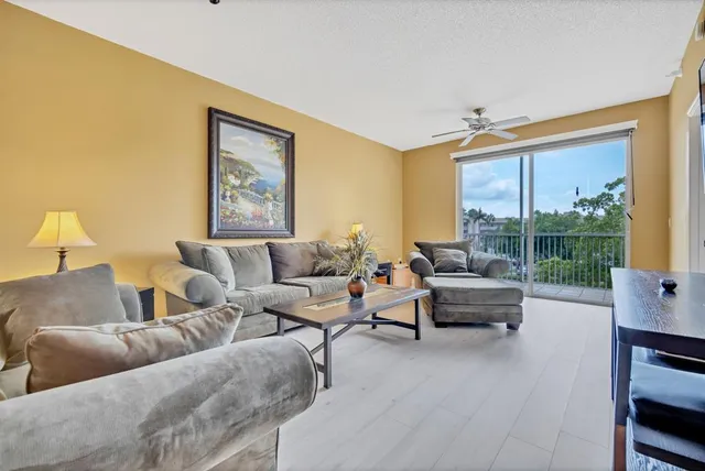 a living room with furniture and a floor to ceiling window