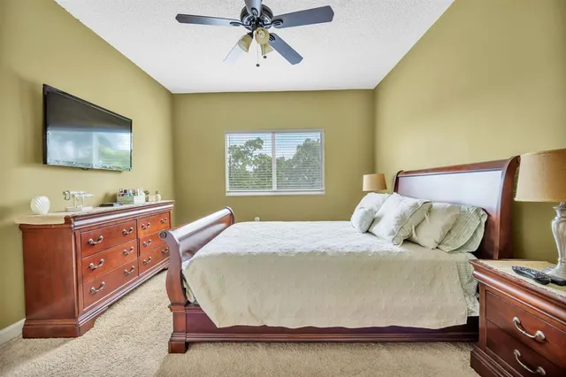 a bedroom with a bed and painting on the wall