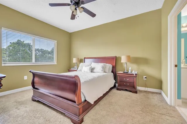 a spacious bedroom with a bed and window