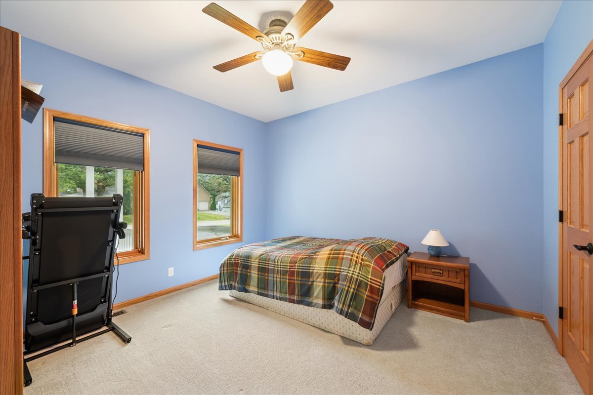11605 Ellwood Greens Road Genoa, IL 60135 - Photo 15 of 25 a bedroom with a bed and a chandelier