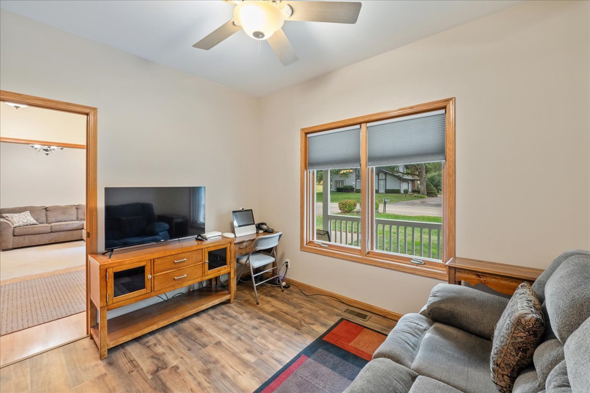 11605 Ellwood Greens Road Genoa, IL 60135 - Photo 17 of 25 a living room with furniture and a flat screen tv