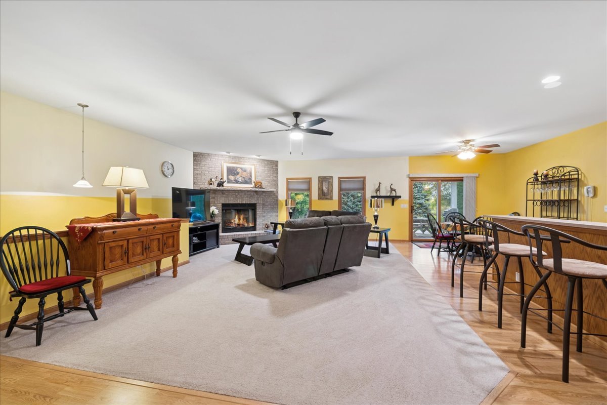 11605 Ellwood Greens Road Genoa, IL 60135 - Photo 3 of 25 a living room with furniture and a dining table with bookshelf