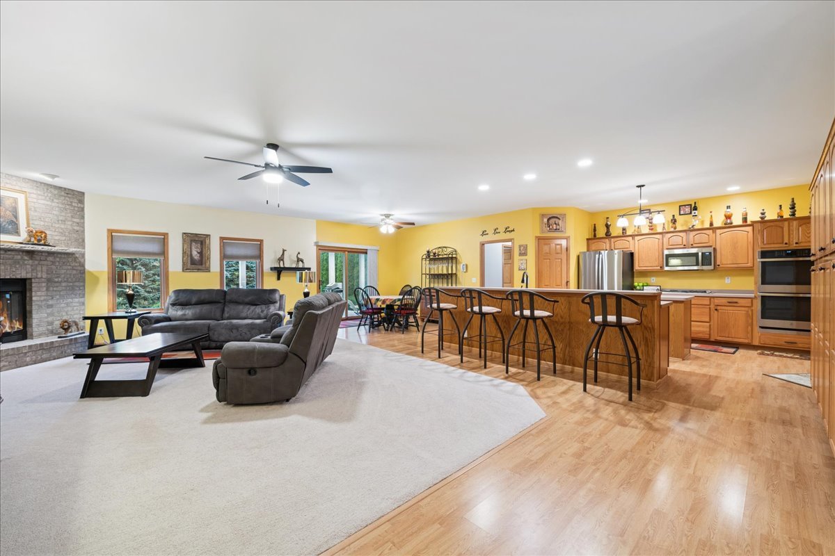 11605 Ellwood Greens Road Genoa, IL 60135 - Photo 4 of 25 a living room with lots of furniture and a view of kitchen