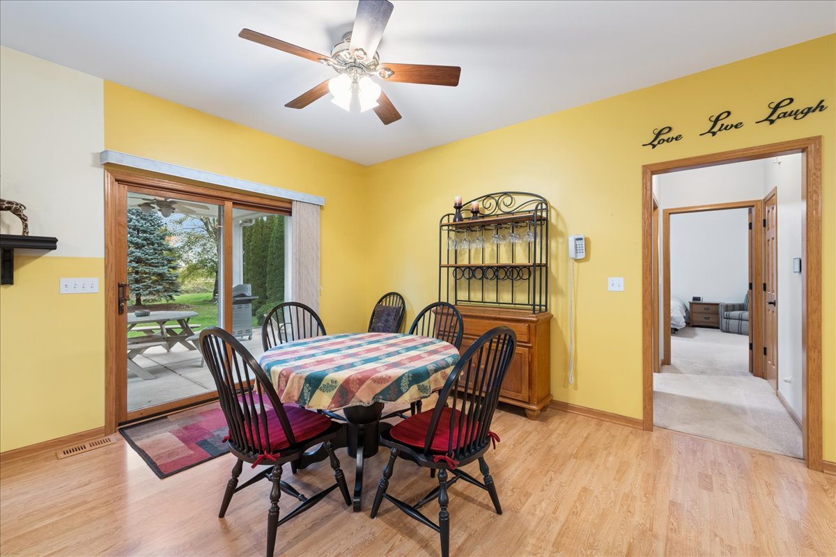 11605 Ellwood Greens Road Genoa, IL 60135 - Photo 9 of 25 a view of a dining room with furniture window and wooden floor