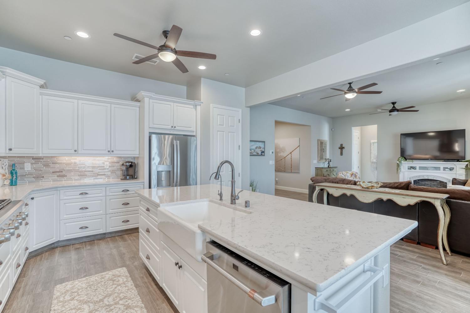 3048 Poe Avenue Clovis, CA 93619 - Photo 17 of 56 a kitchen with a stove a sink and a refrigerator
