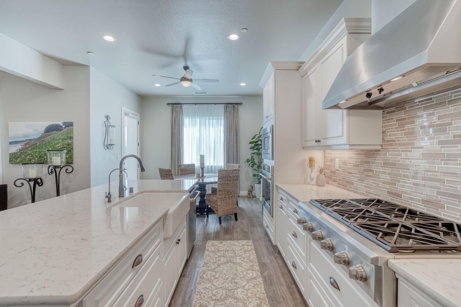 3048 Poe Avenue Clovis, CA 93619 - Photo 20 of 56 a kitchen with sink stove and cabinets
