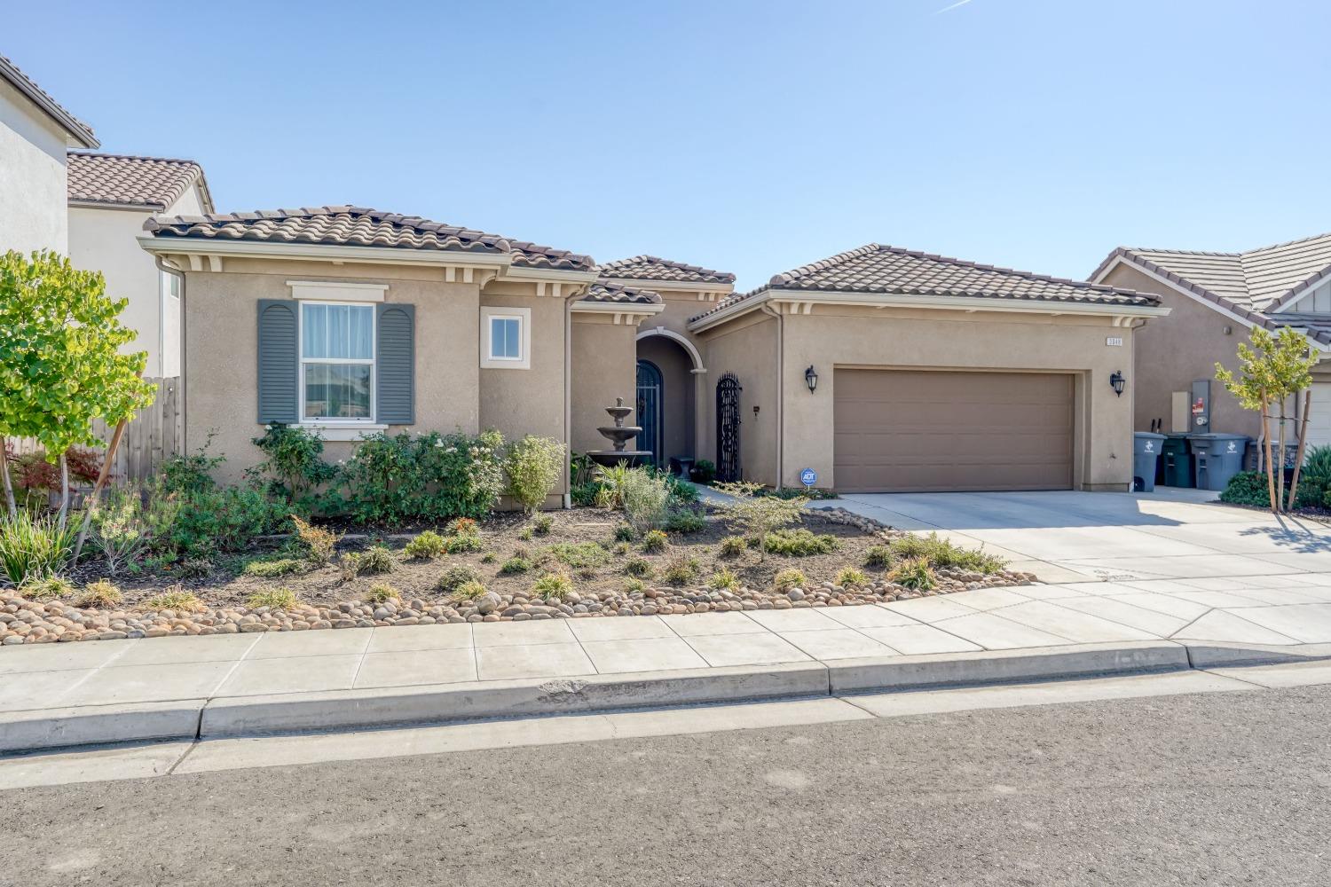 3048 Poe Avenue Clovis, CA 93619 - Photo 2 of 56 a view of a white house with a outdoor space