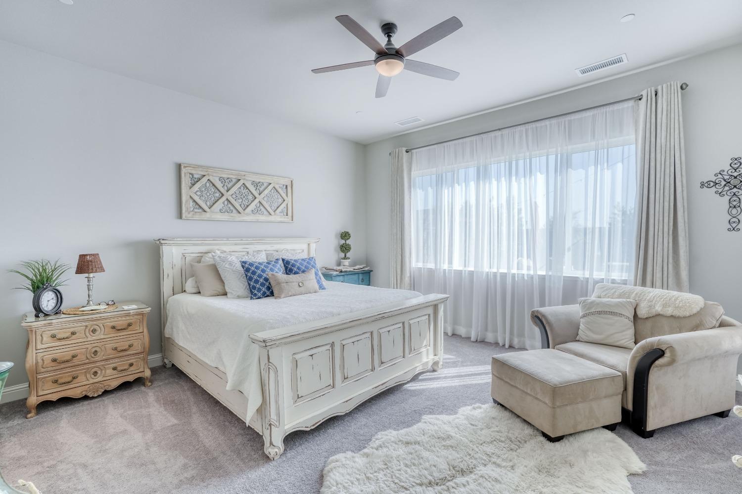 3048 Poe Avenue Clovis, CA 93619 - Photo 24 of 56 a bedroom with a bed couch and a window