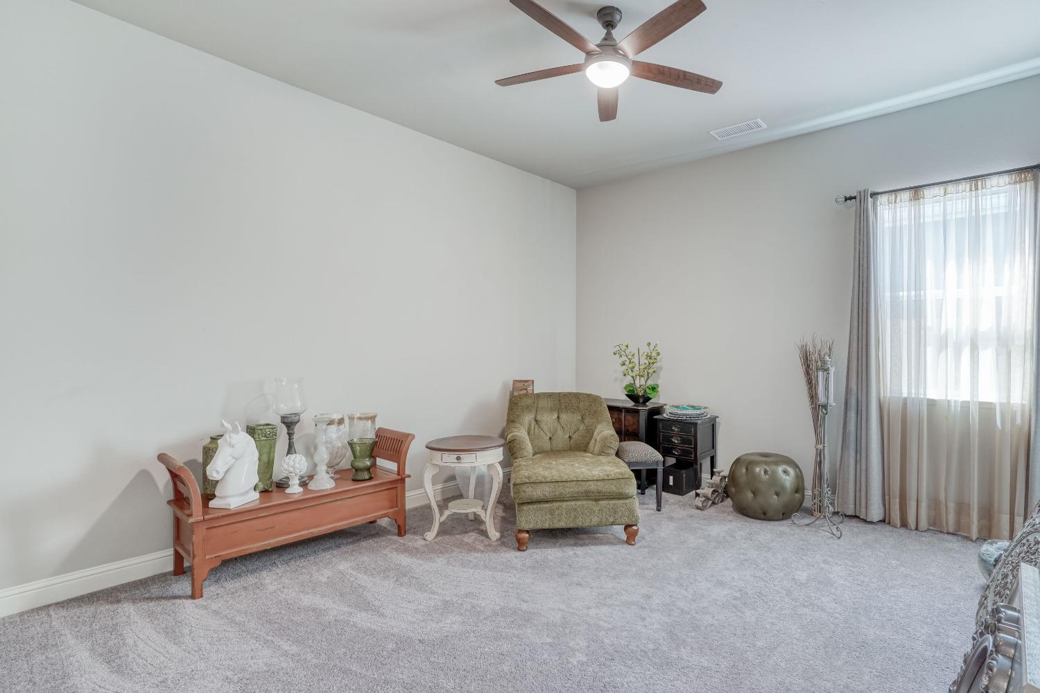 3048 Poe Avenue Clovis, CA 93619 - Photo 28 of 56 a living room with furniture and a chandelier