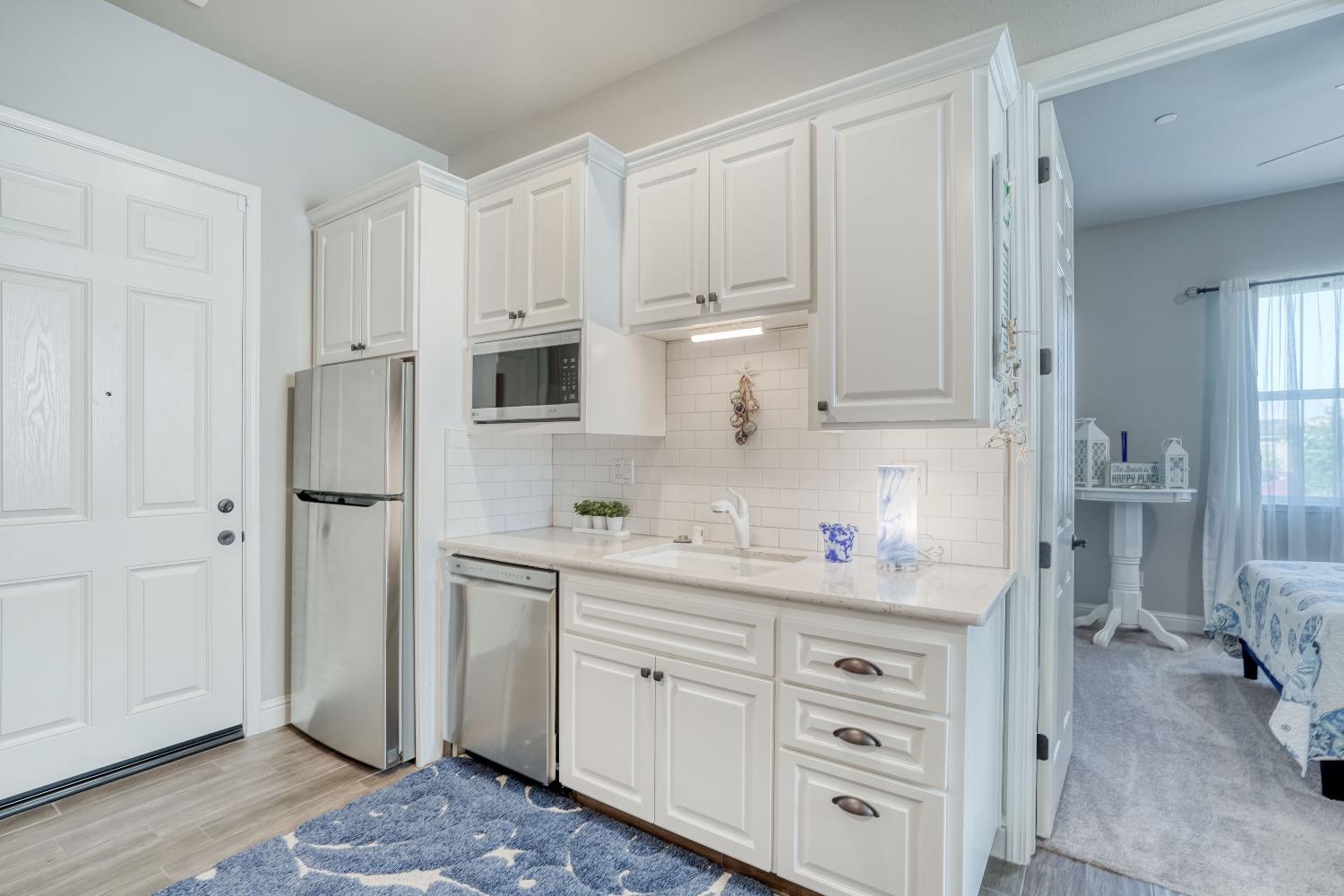 3048 Poe Avenue Clovis, CA 93619 - Photo 35 of 56 a kitchen with white cabinets and refrigerator