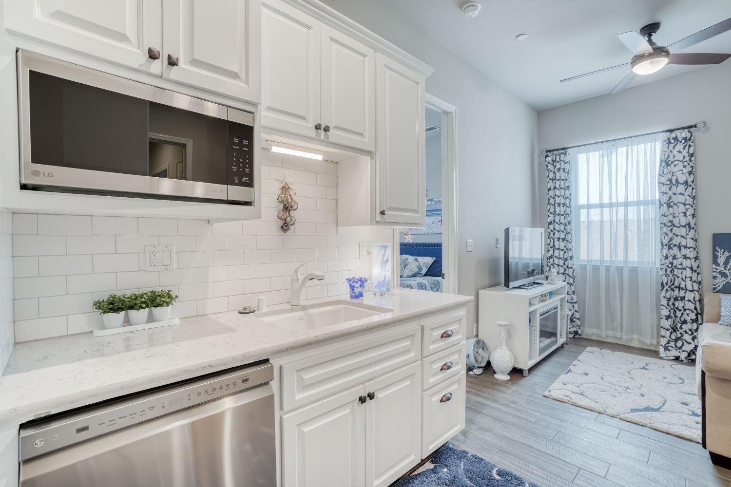 3048 Poe Avenue Clovis, CA 93619 - Photo 36 of 56 a kitchen with stainless steel appliances a white cabinets and a stove top oven