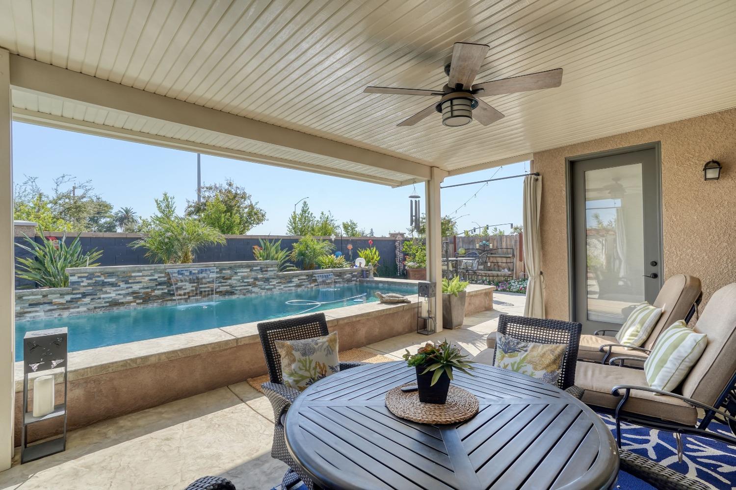 3048 Poe Avenue Clovis, CA 93619 - Photo 40 of 56 a living room with furniture and a floor to ceiling window