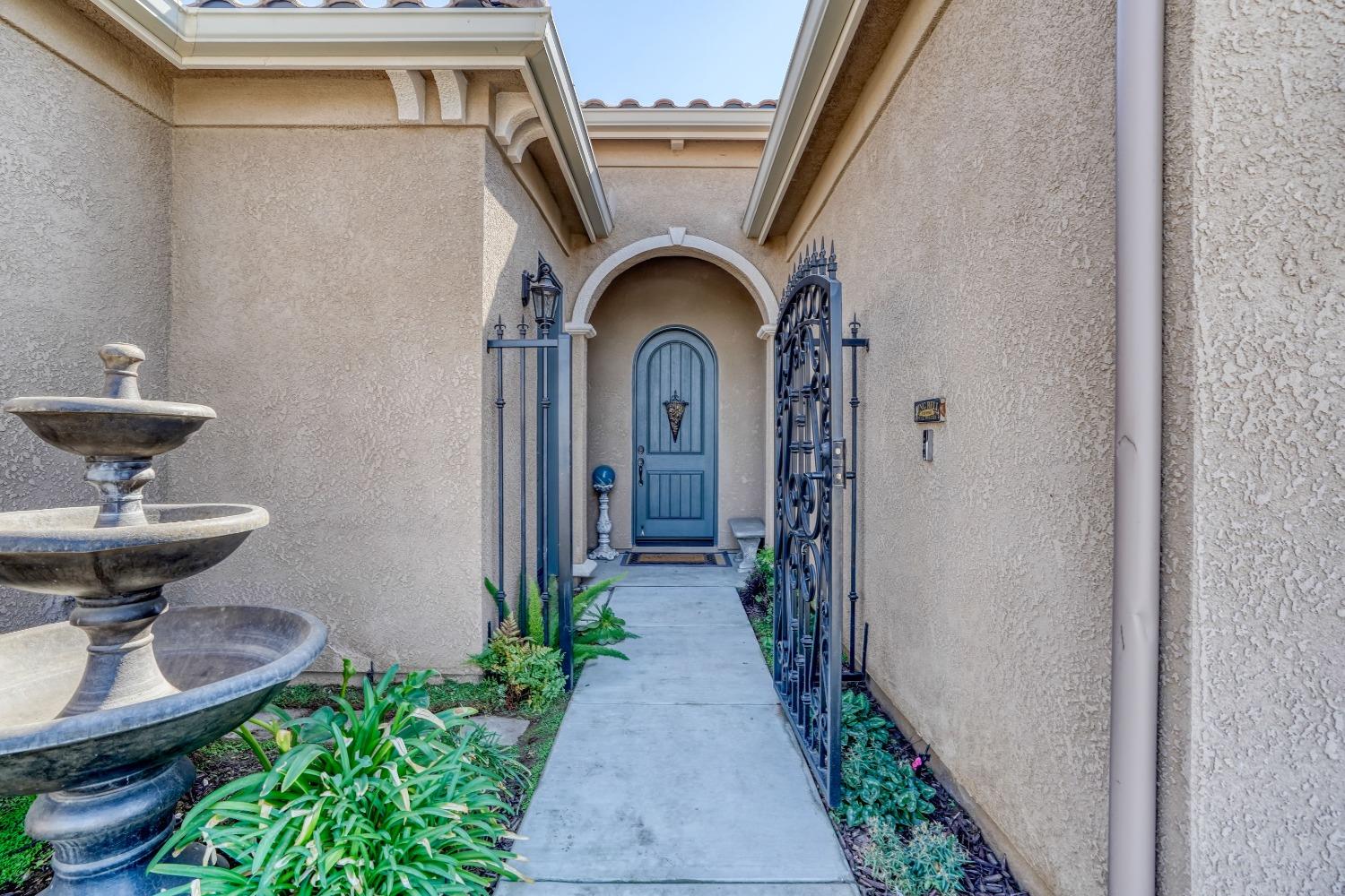 3048 Poe Avenue Clovis, CA 93619 - Photo 4 of 56 a front view of a house with garden