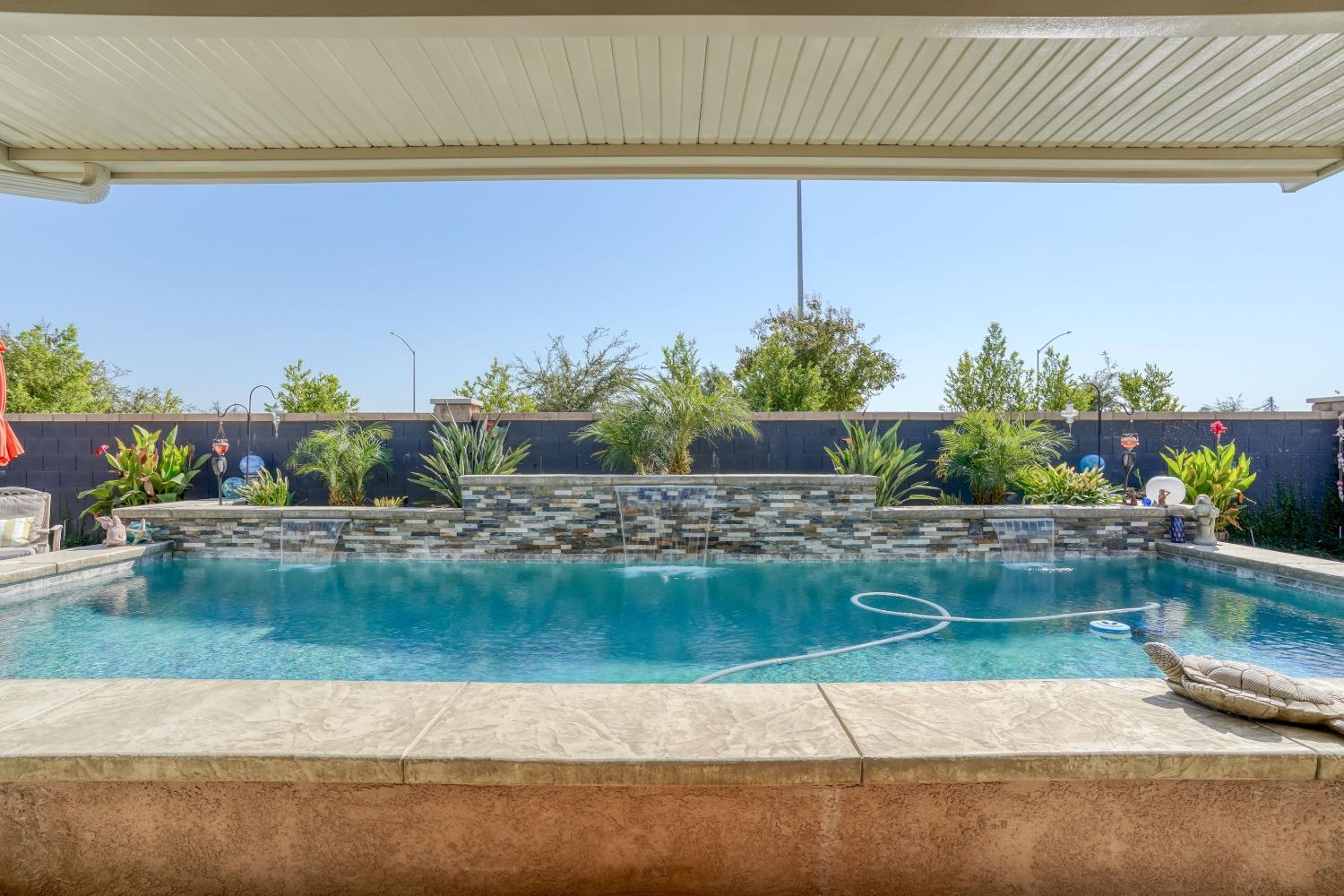 3048 Poe Avenue Clovis, CA 93619 - Photo 41 of 56 a view of a house with a yard swimming pool and outdoor seating