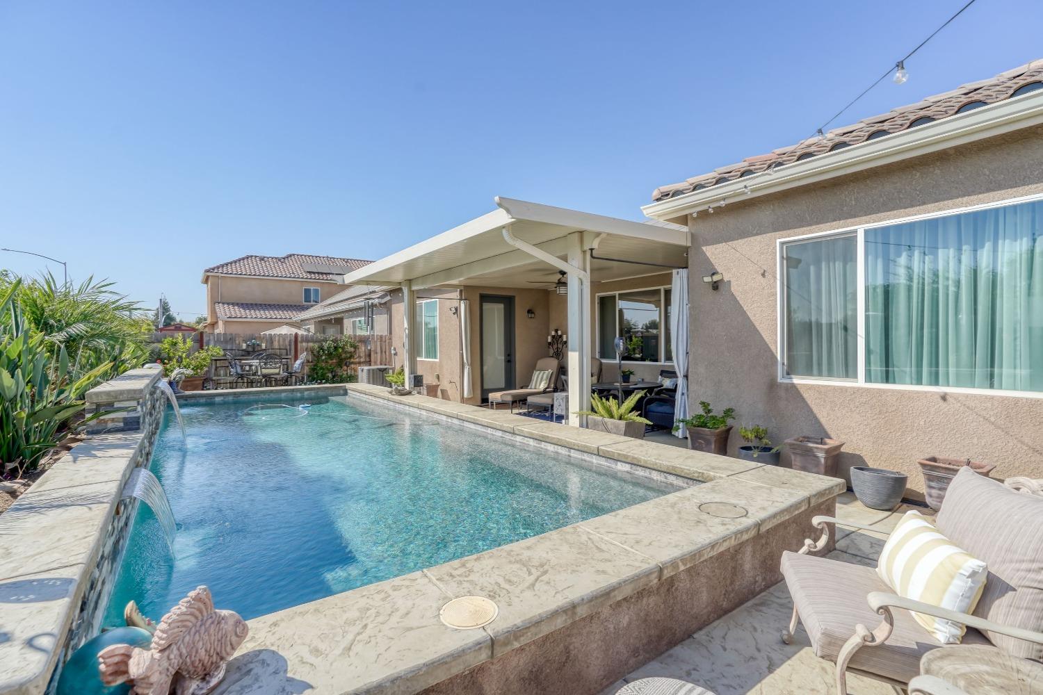 3048 Poe Avenue Clovis, CA 93619 - Photo 44 of 56 a view of a house with pool and chairs
