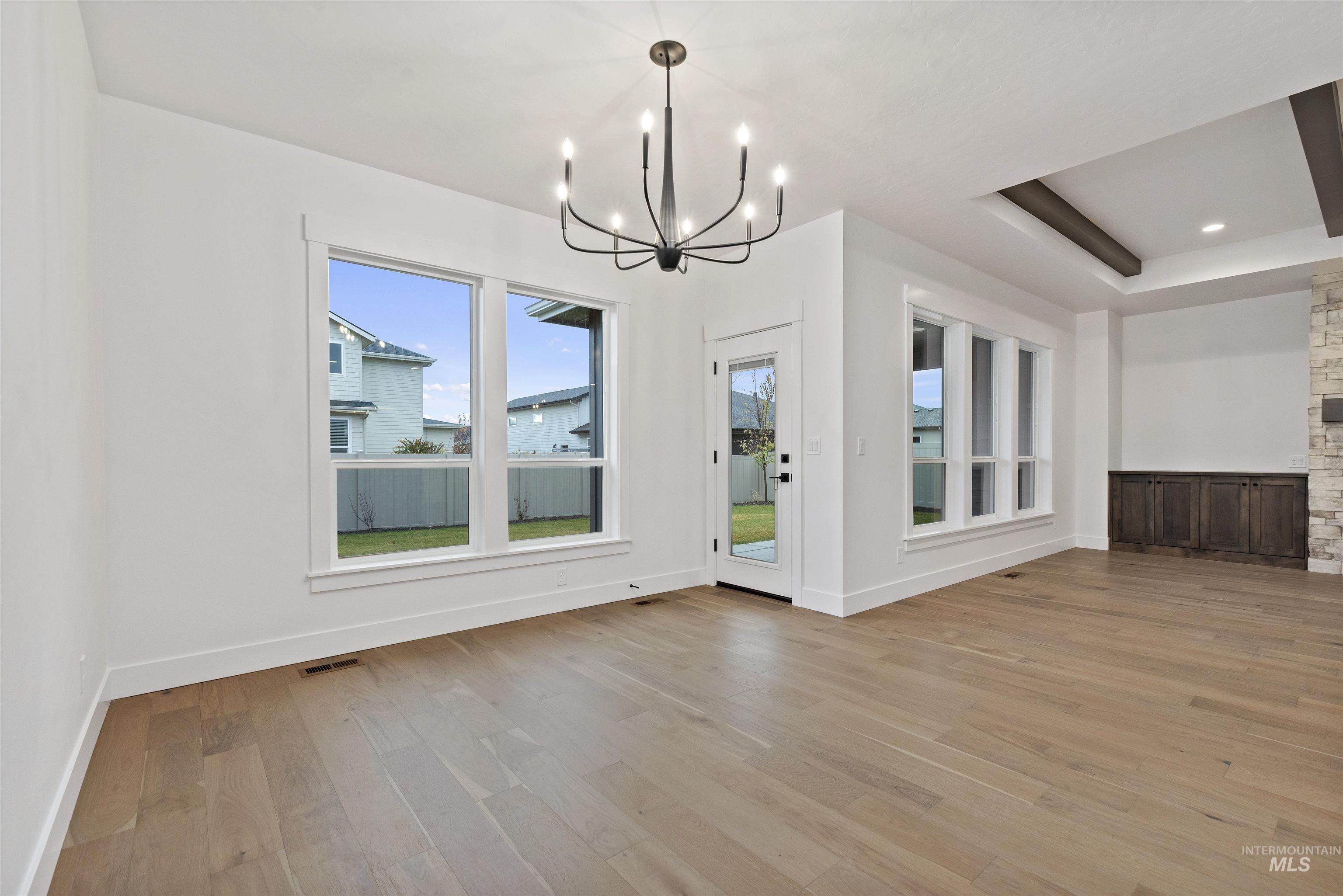 2129 East Blakehurst Street Kuna, ID 83634 - Photo 12 of 34 Unfurnished dining area with light wood finished floors and a chandelier