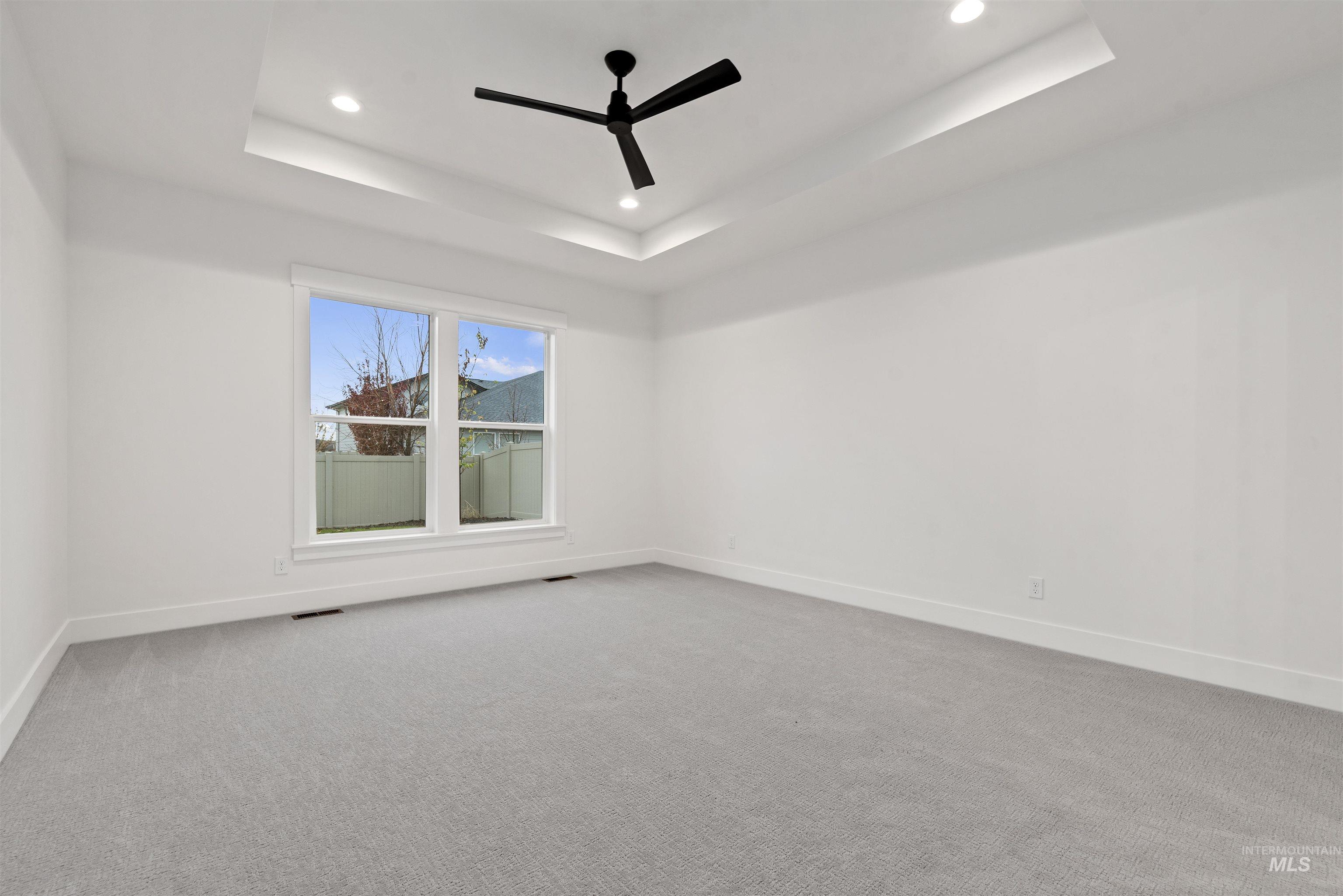 2129 East Blakehurst Street Kuna, ID 83634 - Photo 16 of 34 Spare room with a raised ceiling, light carpet, ceiling fan, and recessed lighting