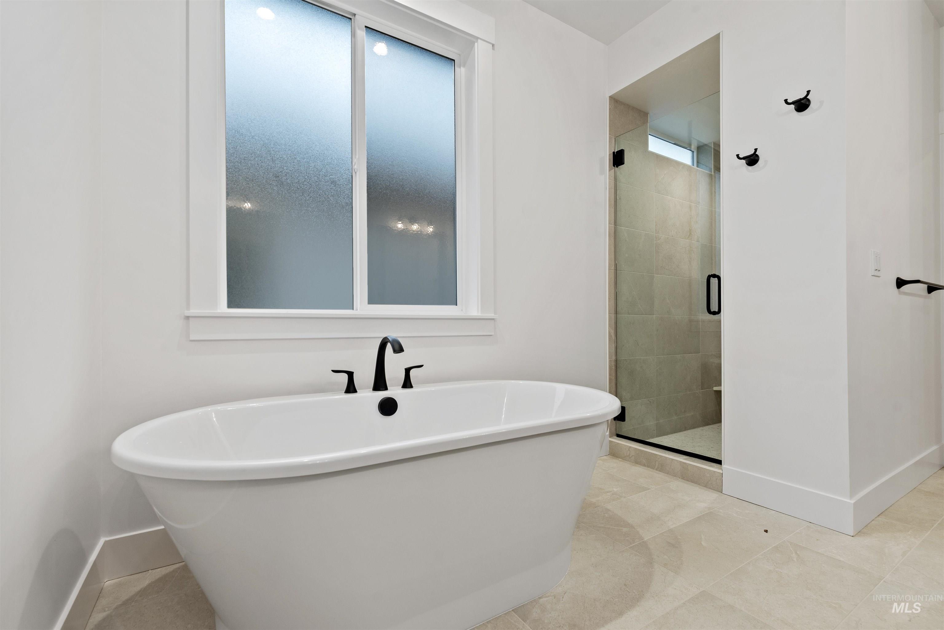 2129 East Blakehurst Street Kuna, ID 83634 - Photo 17 of 34 Full bathroom featuring a soaking tub and a stall shower