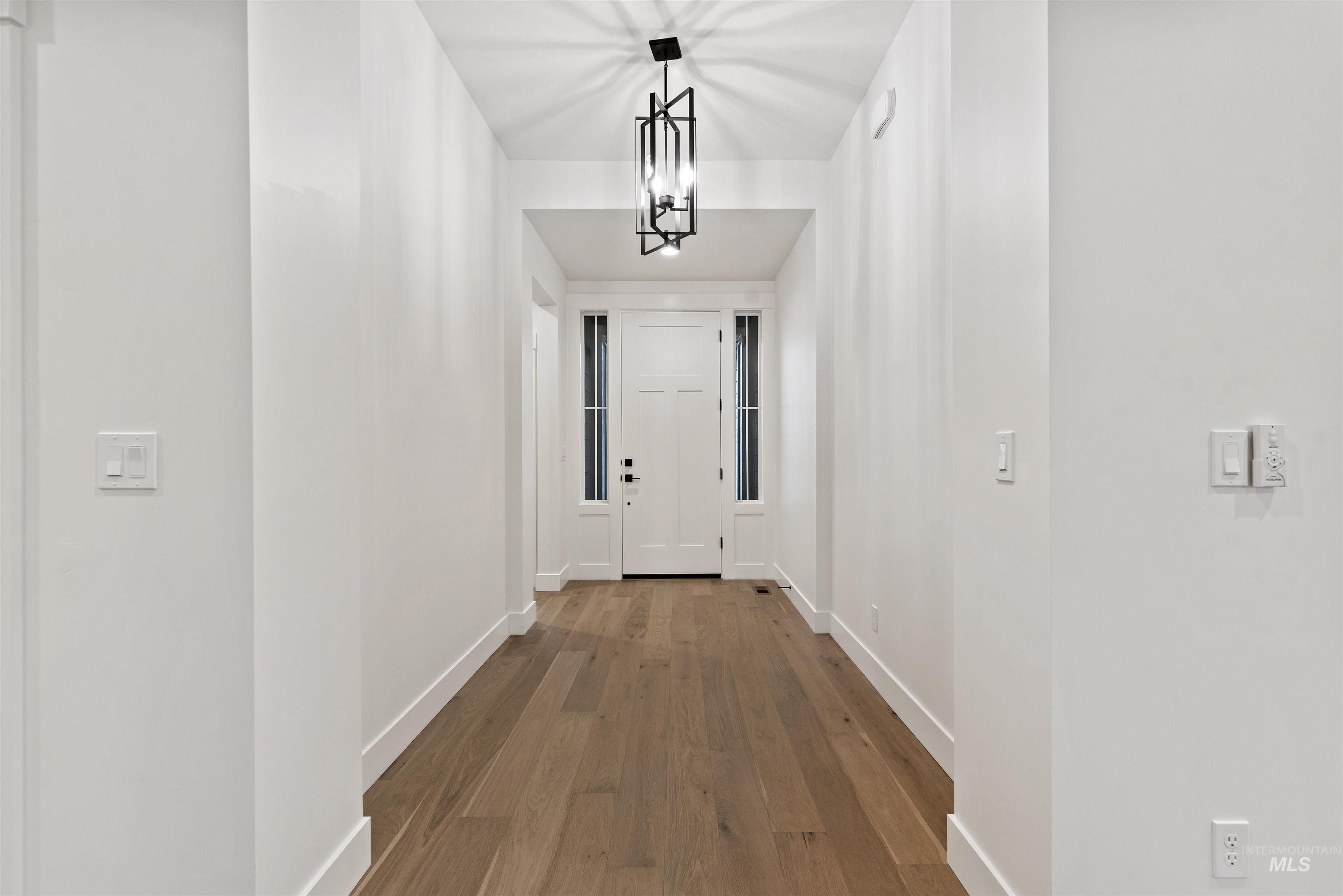 2129 East Blakehurst Street Kuna, ID 83634 - Photo 2 of 34 Entryway with wood finished floors and a chandelier