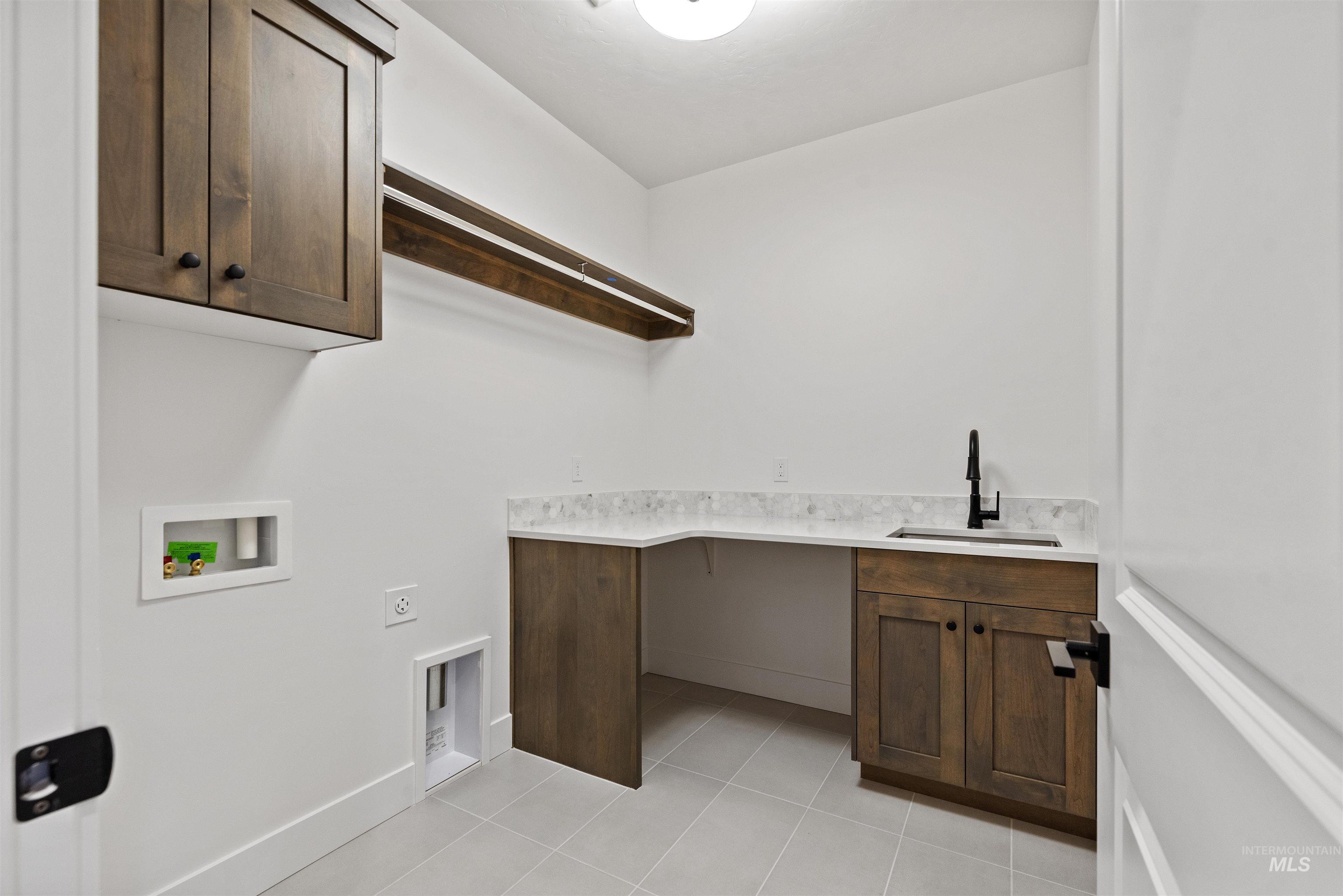 2129 East Blakehurst Street Kuna, ID 83634 - Photo 26 of 34 Laundry area featuring cabinet space, washer hookup, light tile patterned floors, and hookup for an electric dryer