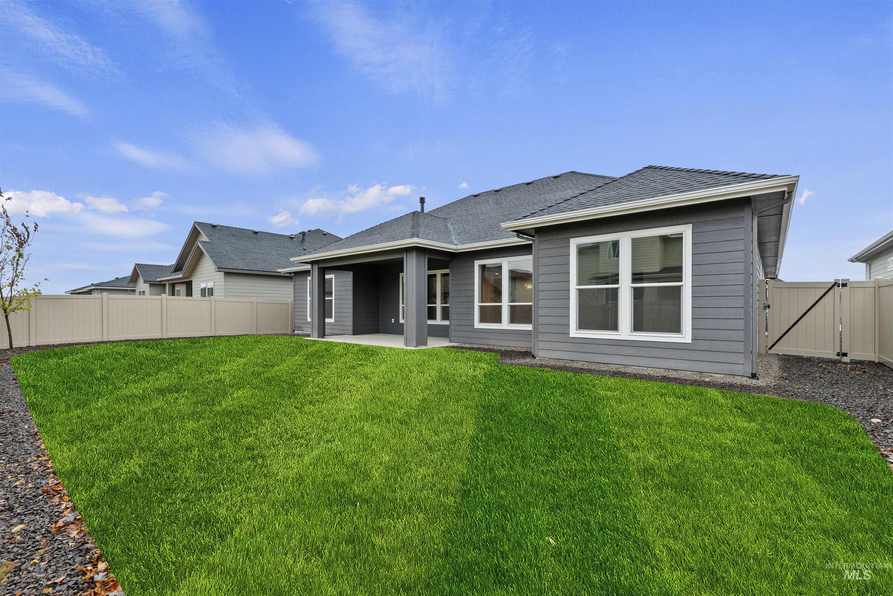 2129 East Blakehurst Street Kuna, ID 83634 - Photo 28 of 34 Back of house featuring a patio area, a fenced backyard, roof with shingles, and a gate